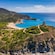 A coastal village in Cagliari, Italy on a hillside peninsula near a beach